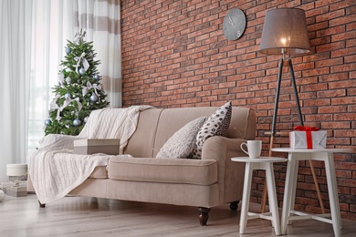 Photo of Decorated Christmas tree in stylish living room interior