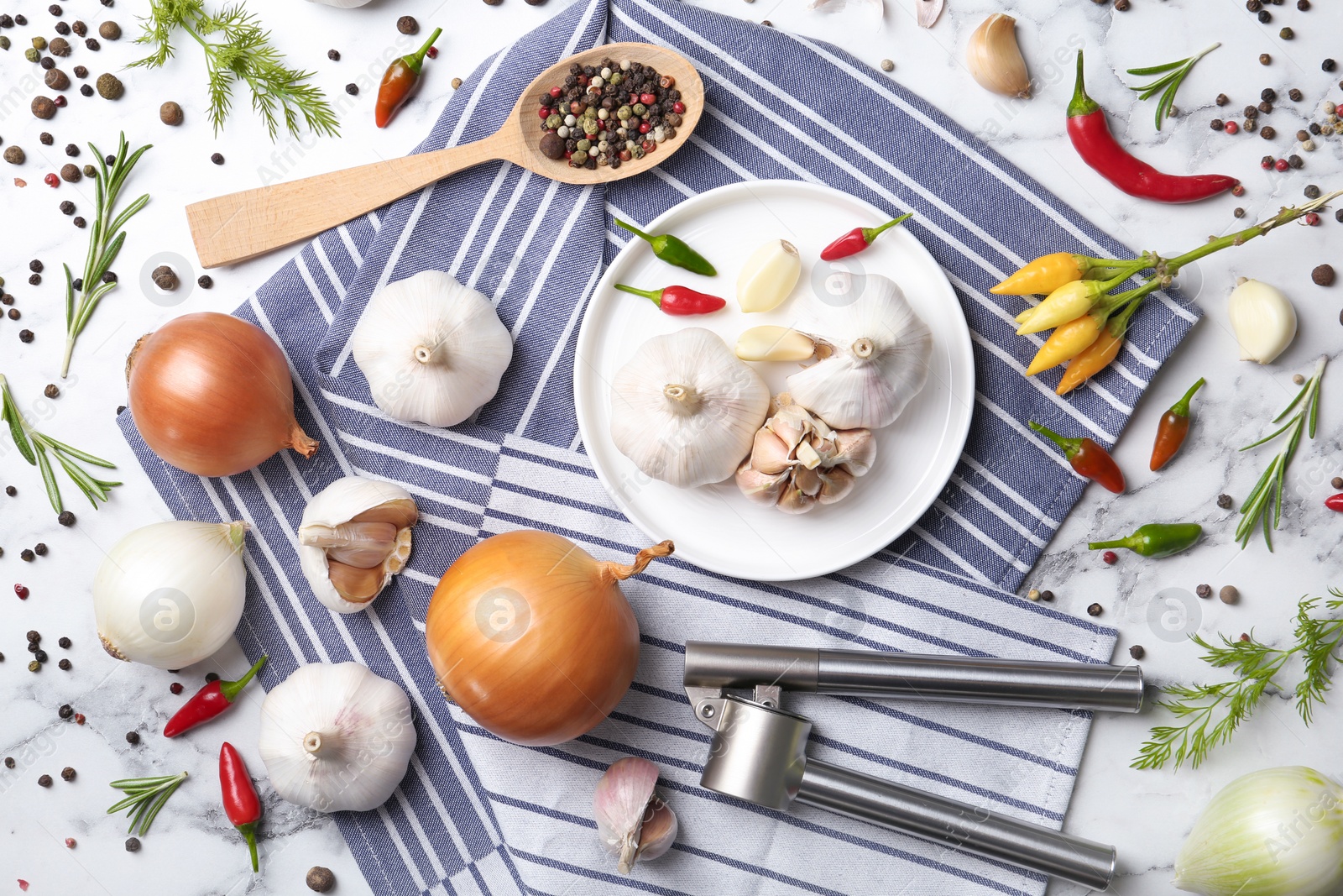 Photo of Flat lay composition with garlic, peppers and onions on marble table