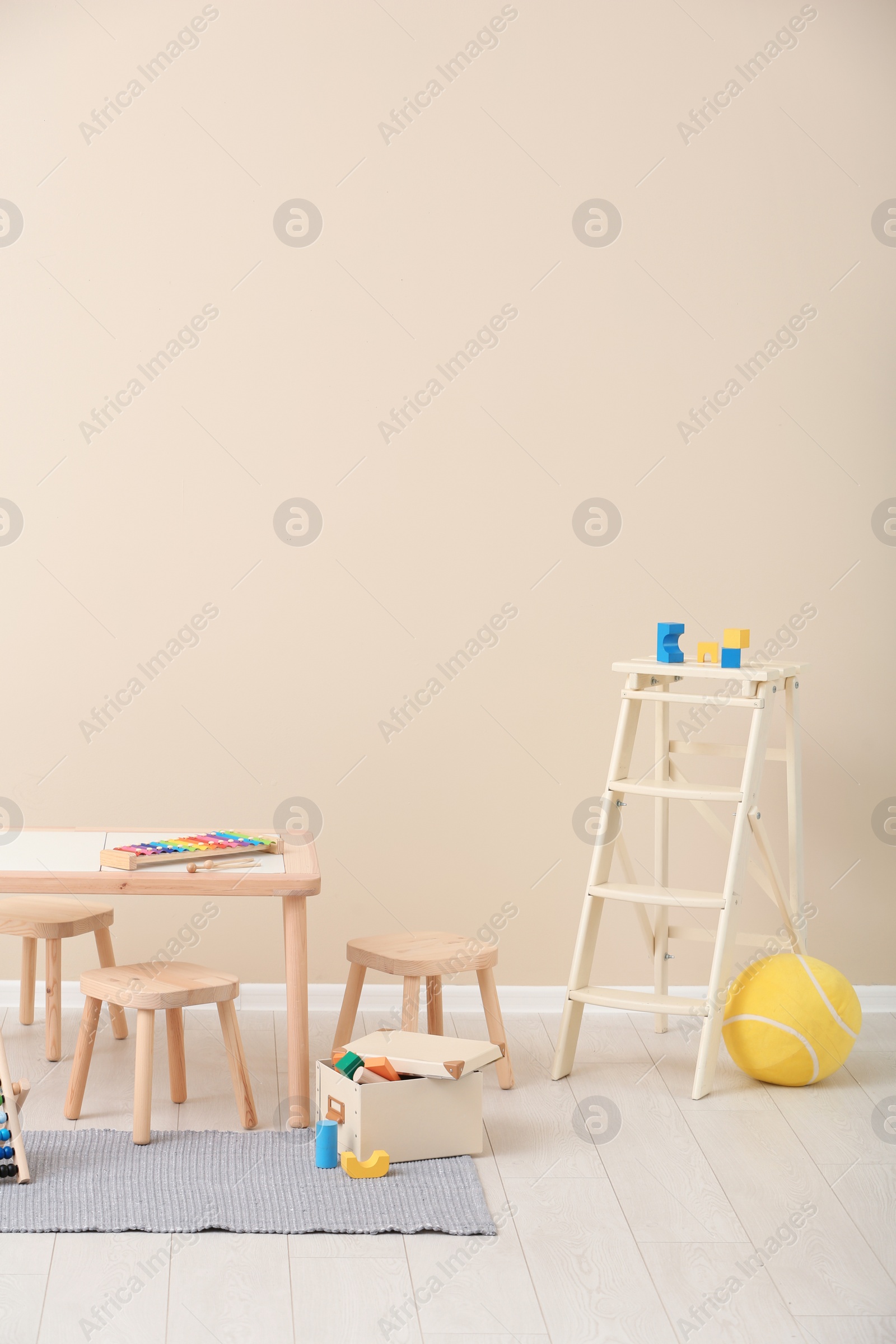 Photo of Stylish child's room interior with toys and new furniture, space for text