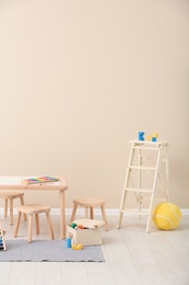 Photo of Stylish child's room interior with toys and new furniture, space for text