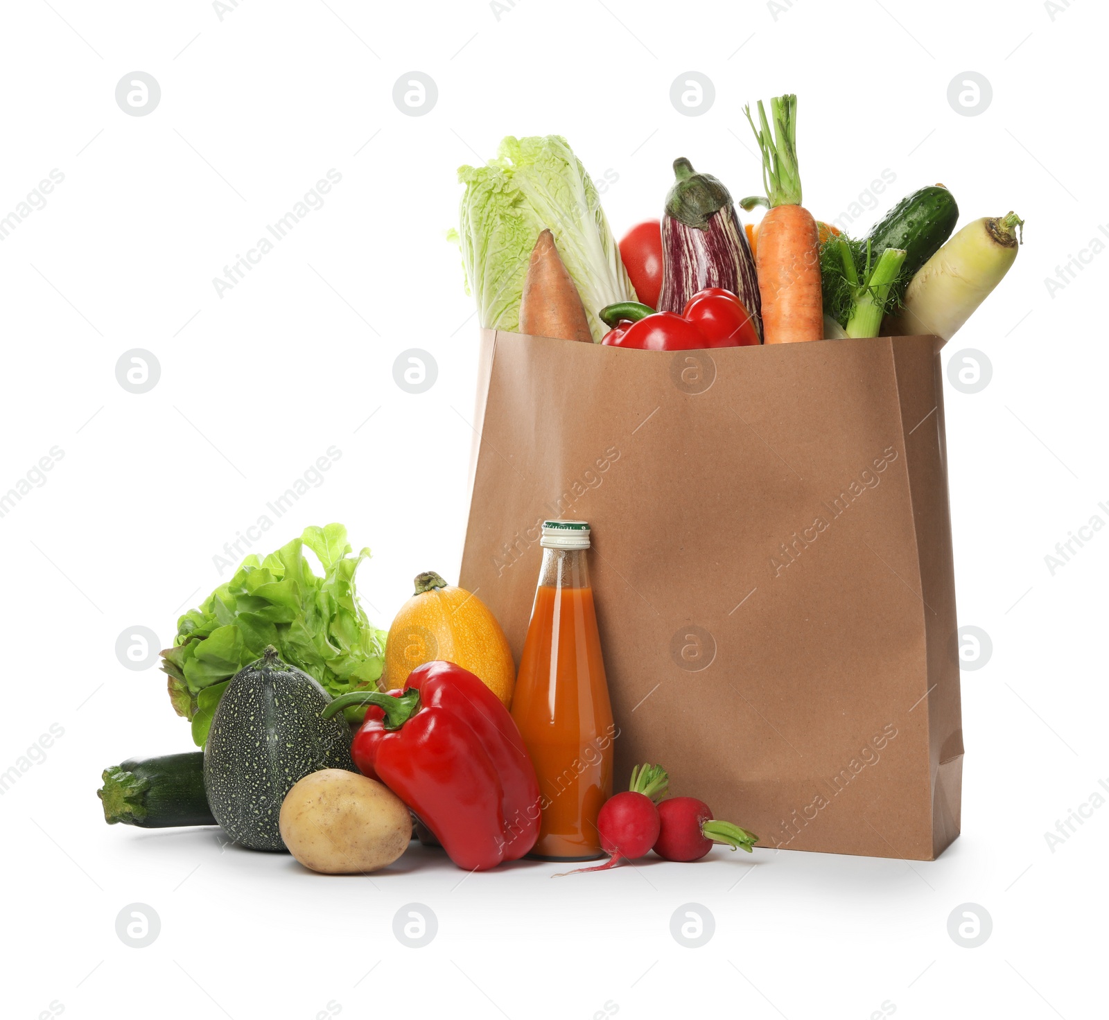 Photo of Paper bag with fresh vegetables and bottle of juice on white background
