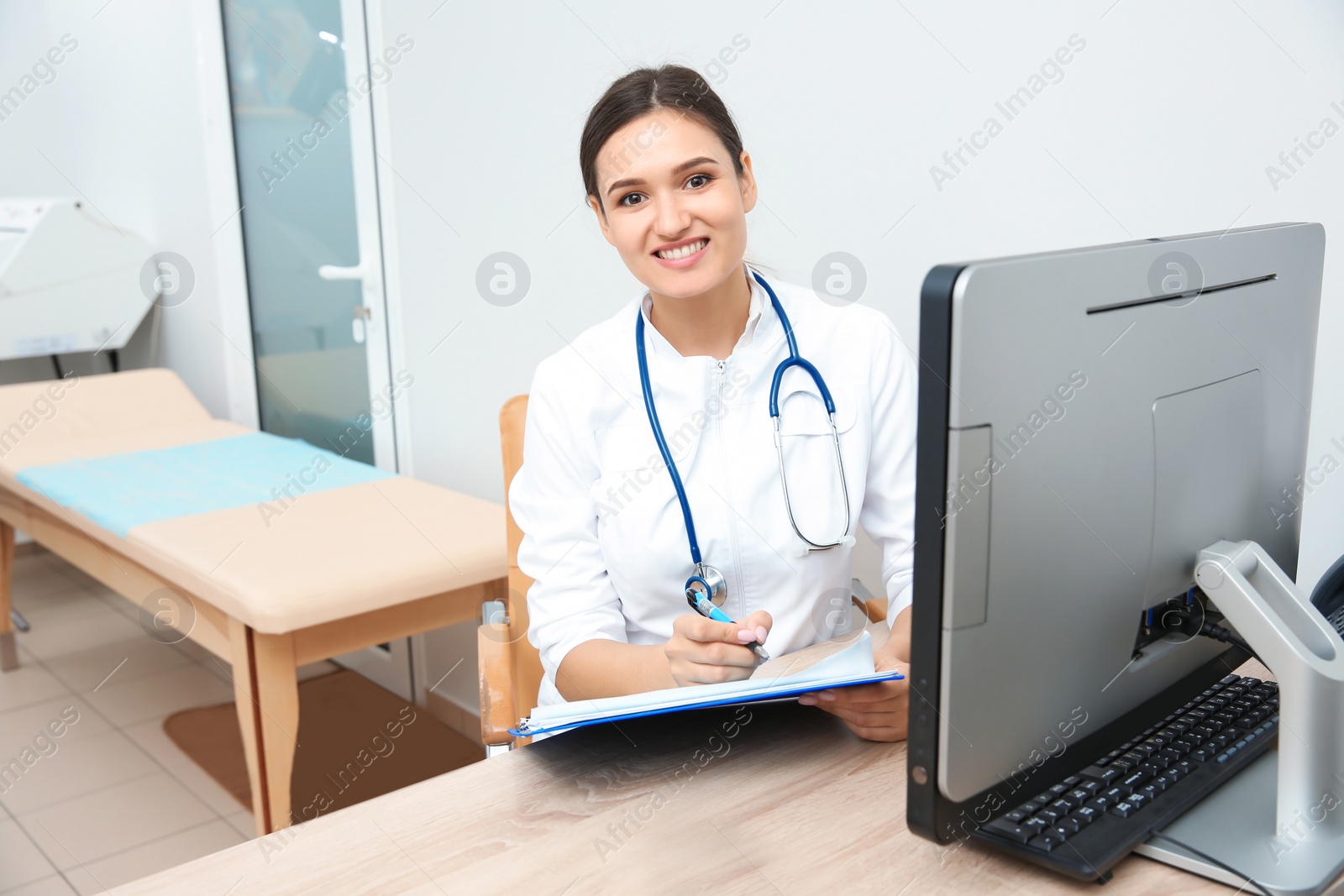 Photo of Portrait of young gynecologist at table in hospital