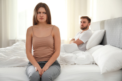 Photo of Unhappy couple with relationship problems after quarrel in bedroom