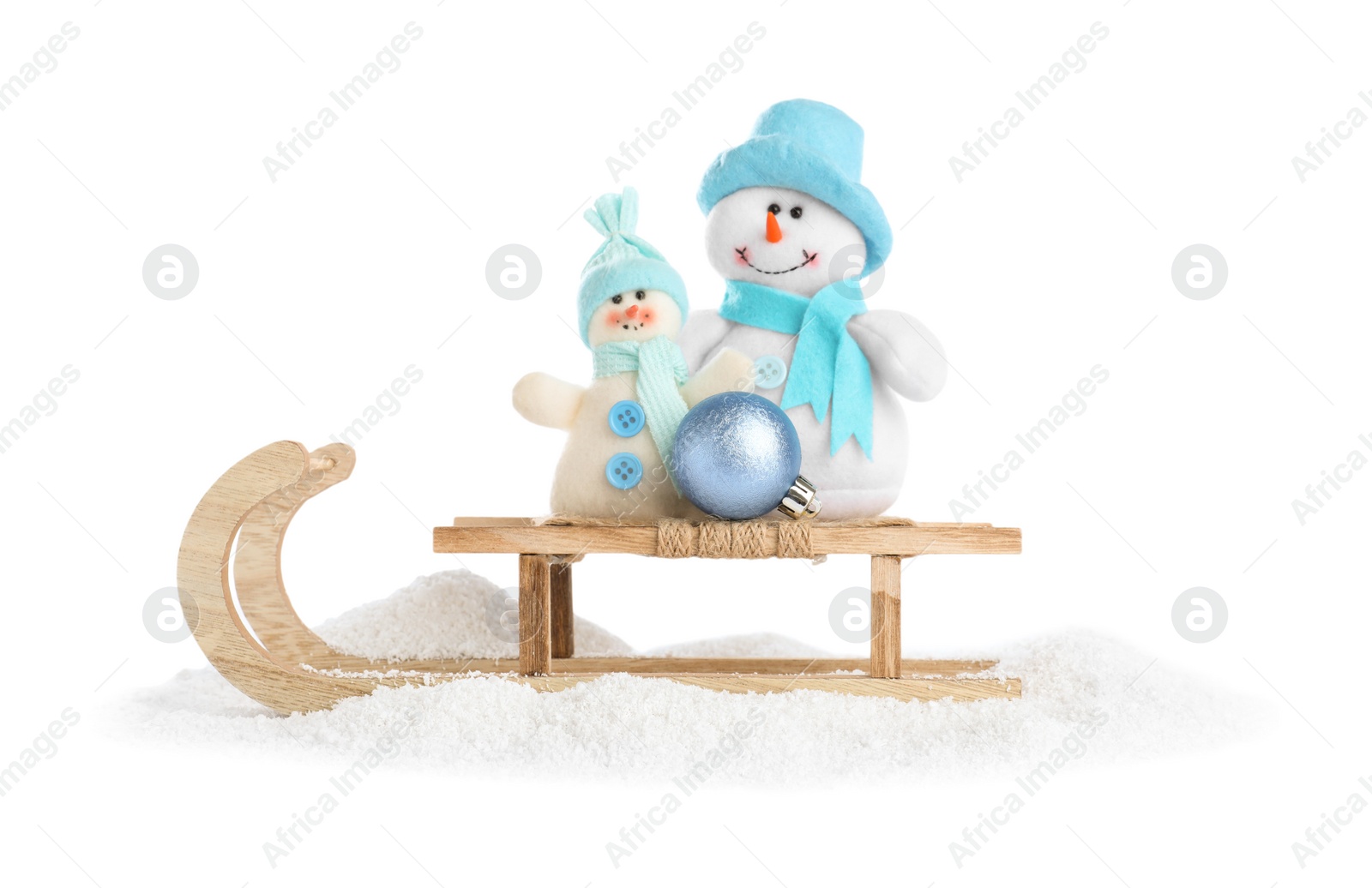 Photo of Wooden sleigh with snowmen on white background. Christmas holiday decor