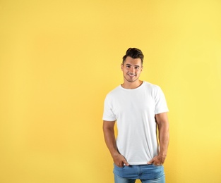 Photo of Young man in t-shirt on color background. Mockup for design