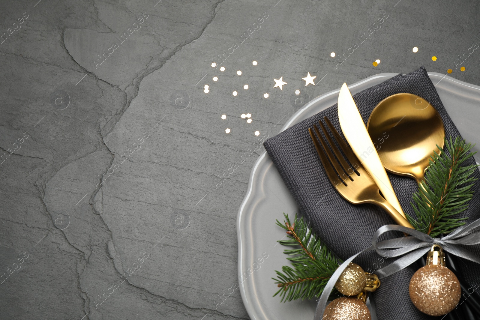 Photo of Festive table setting with beautiful dishware and Christmas decor on black background, flat lay. Space for text