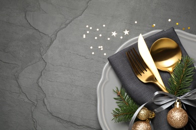 Photo of Festive table setting with beautiful dishware and Christmas decor on black background, flat lay. Space for text