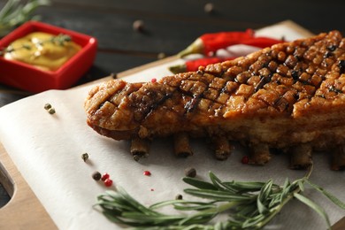 Delicious roasted ribs served on table, closeup