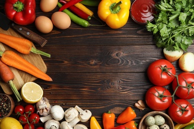 Photo of Frame of ingredients for cooking on wooden table, flat lay. Space for text