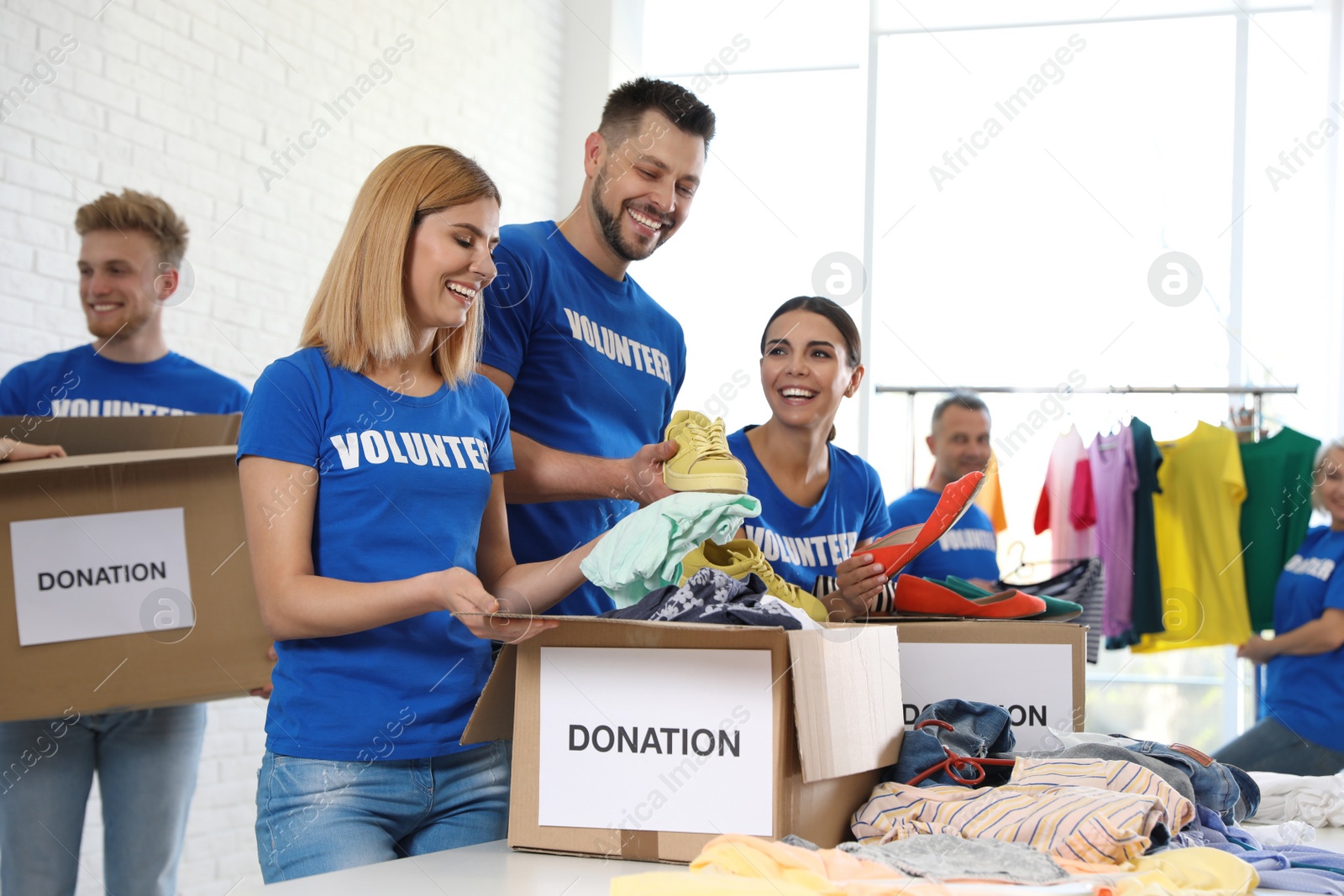 Photo of Team of volunteers collecting donations in boxes indoors