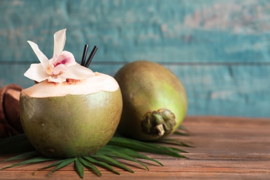 Fresh green coconuts on wooden table