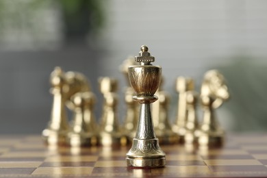 Photo of Golden king on chess board, closeup view