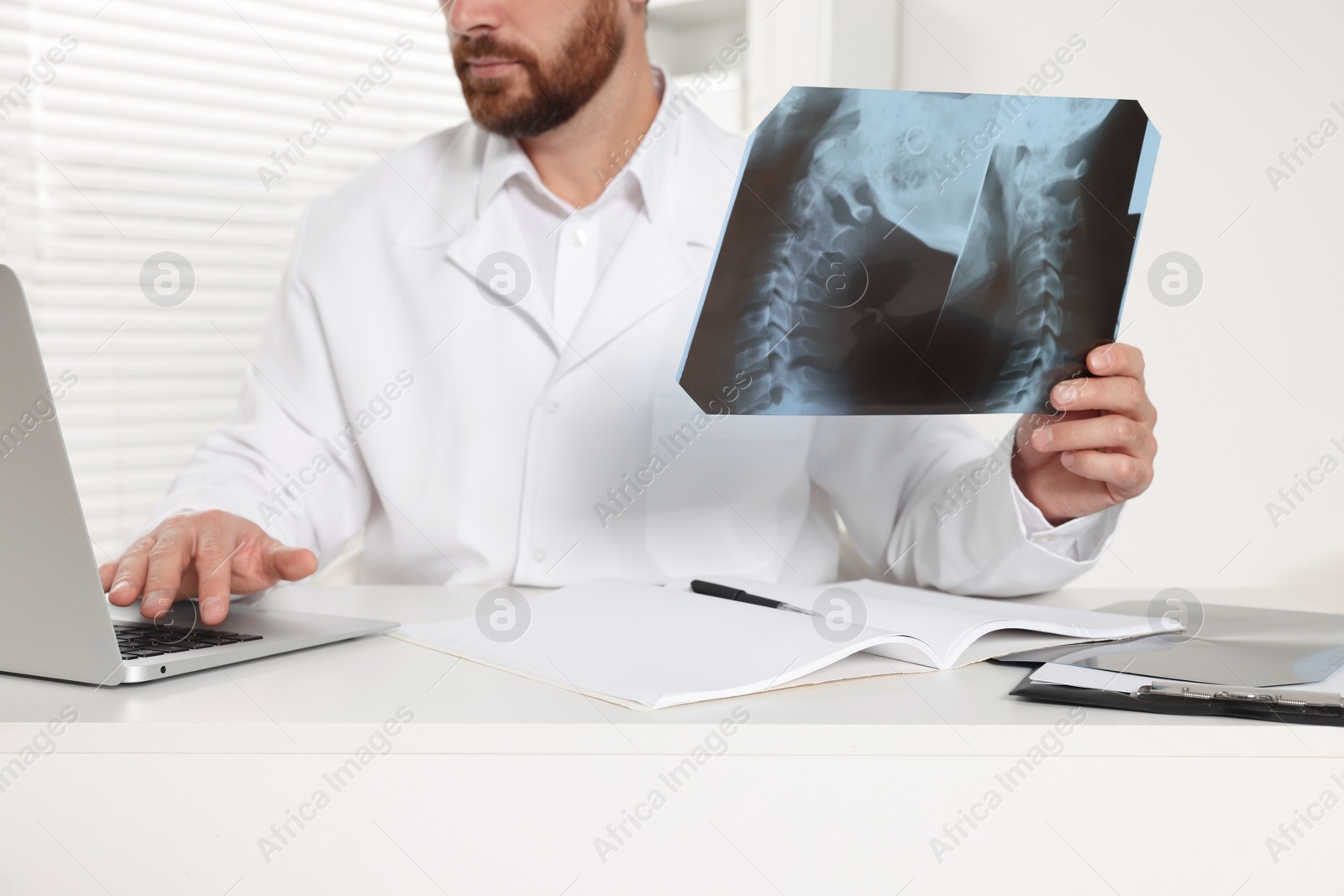 Photo of Doctor examining neck MRI scan in hospital, closeup