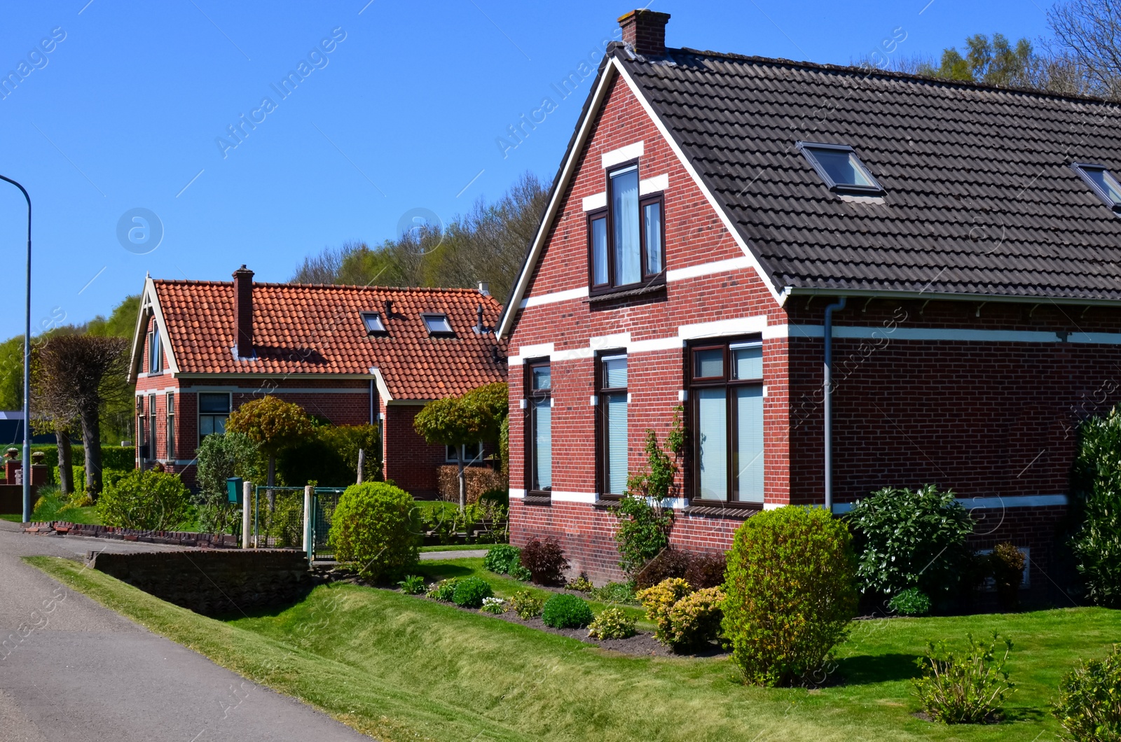 Photo of Suburban street with beautiful buildings on sunny day