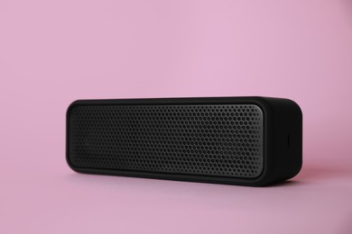 Photo of One portable bluetooth speaker on pink background. Audio equipment