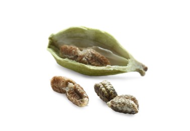 Photo of Seeds of dry green cardamom on white background