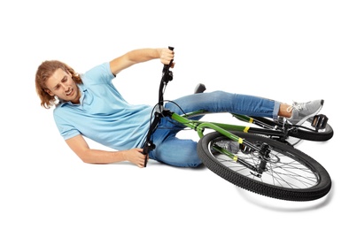Photo of Young man falling off his bicycle on white background