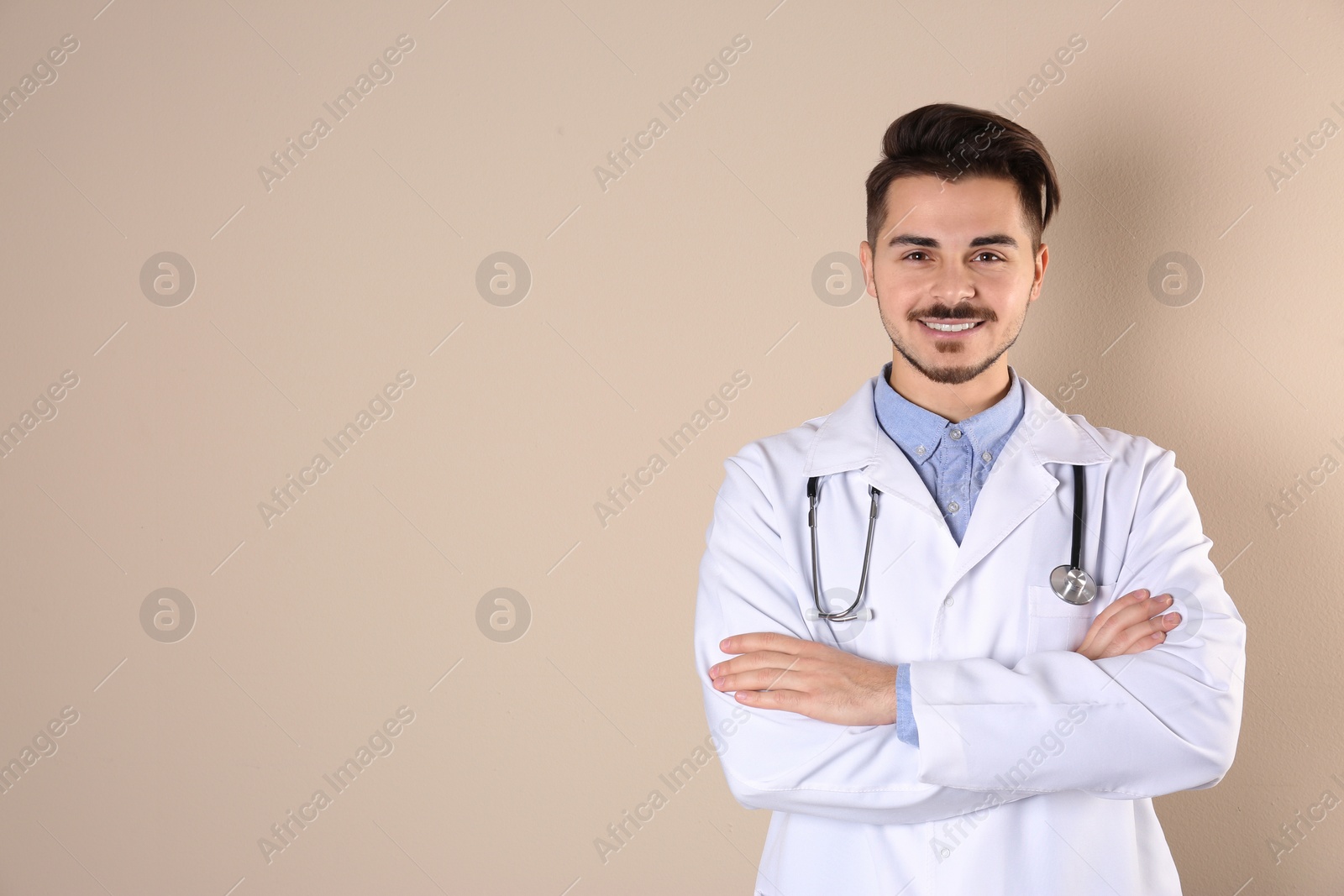 Photo of Young medical student in uniform on color background. Space for text