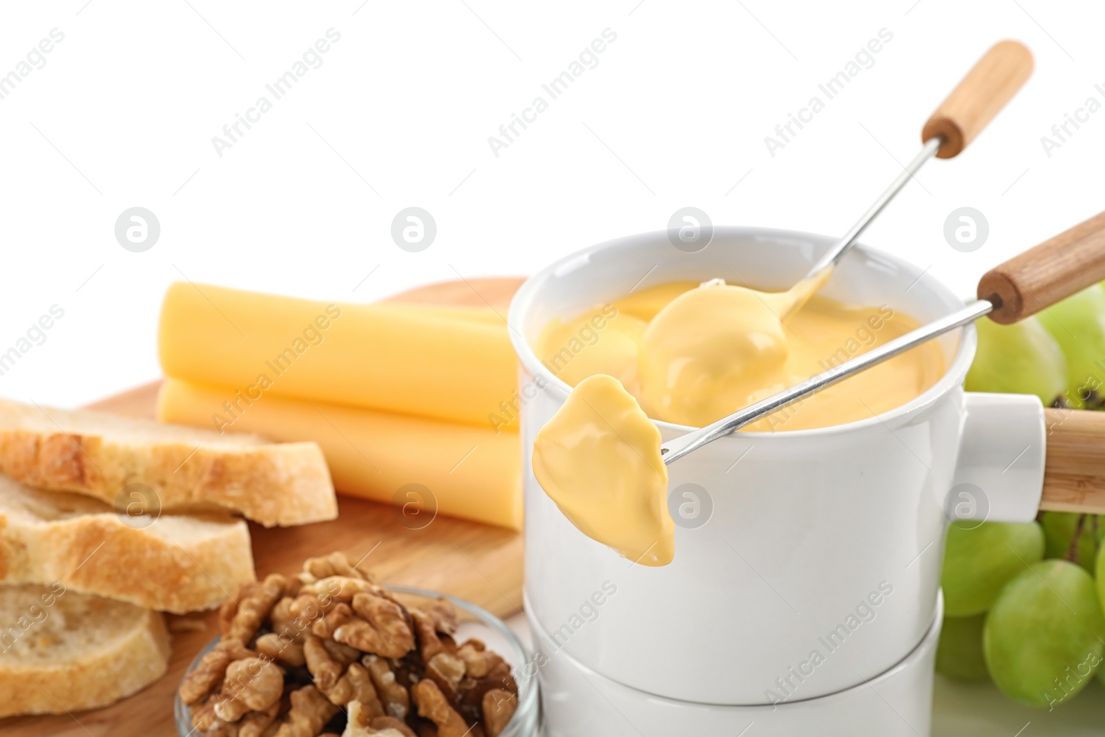 Photo of Pot of tasty cheese fondue and products isolated on white