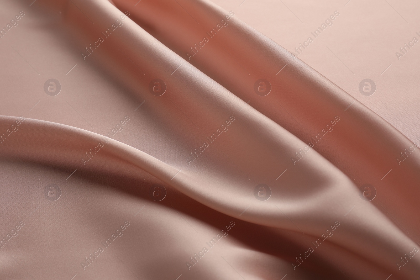 Photo of Crumpled pink silk fabric as background, top view