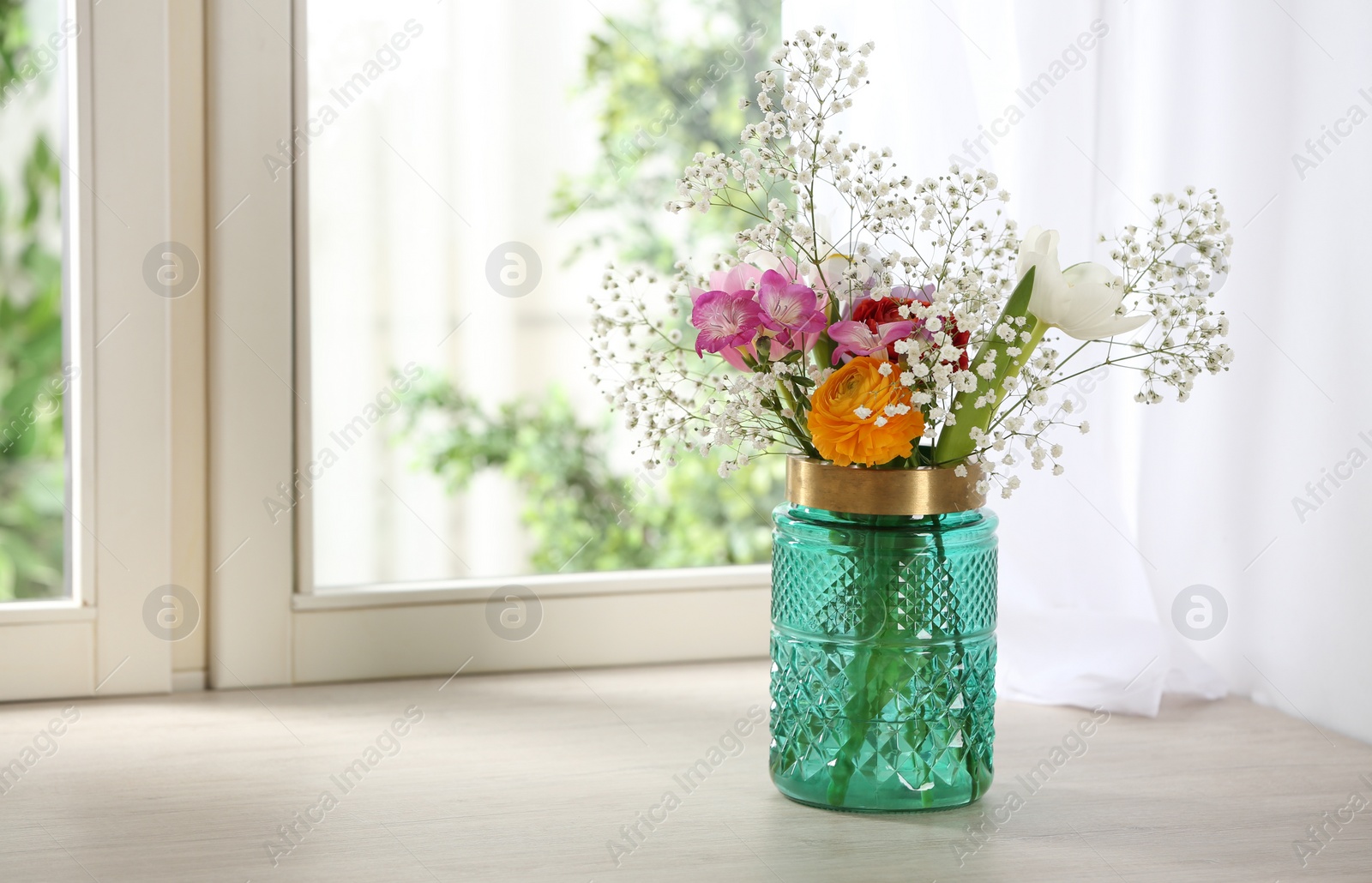 Photo of Beautiful fresh flowers on window sill indoors. Space for text