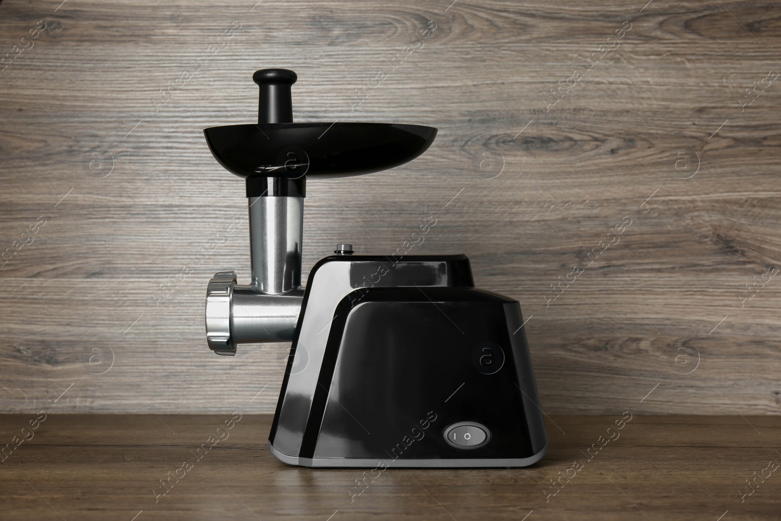 Photo of Modern electric meat grinder on wooden table