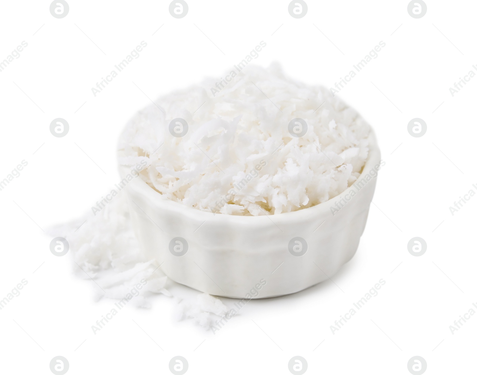 Photo of Coconut flakes in bowl isolated on white