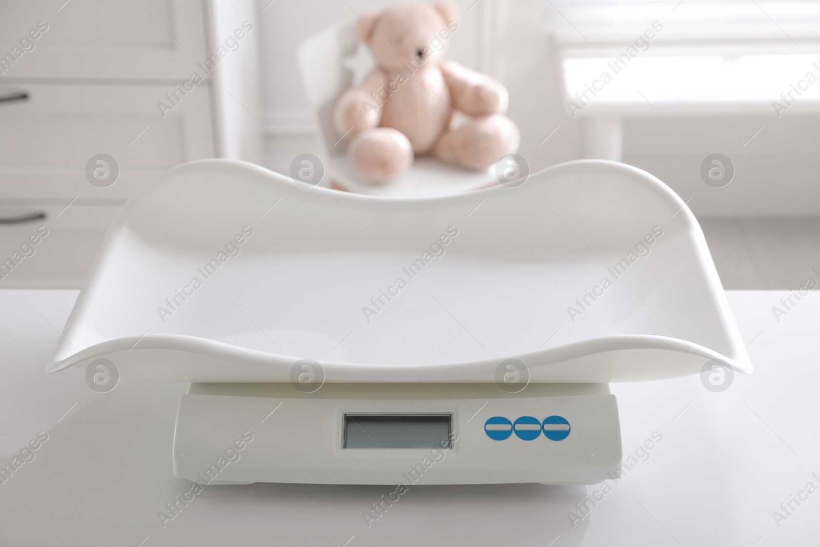 Photo of Modern digital baby scales on table in room