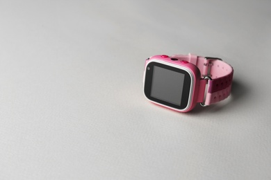 Photo of Modern kid smart watch on grey background, space for text
