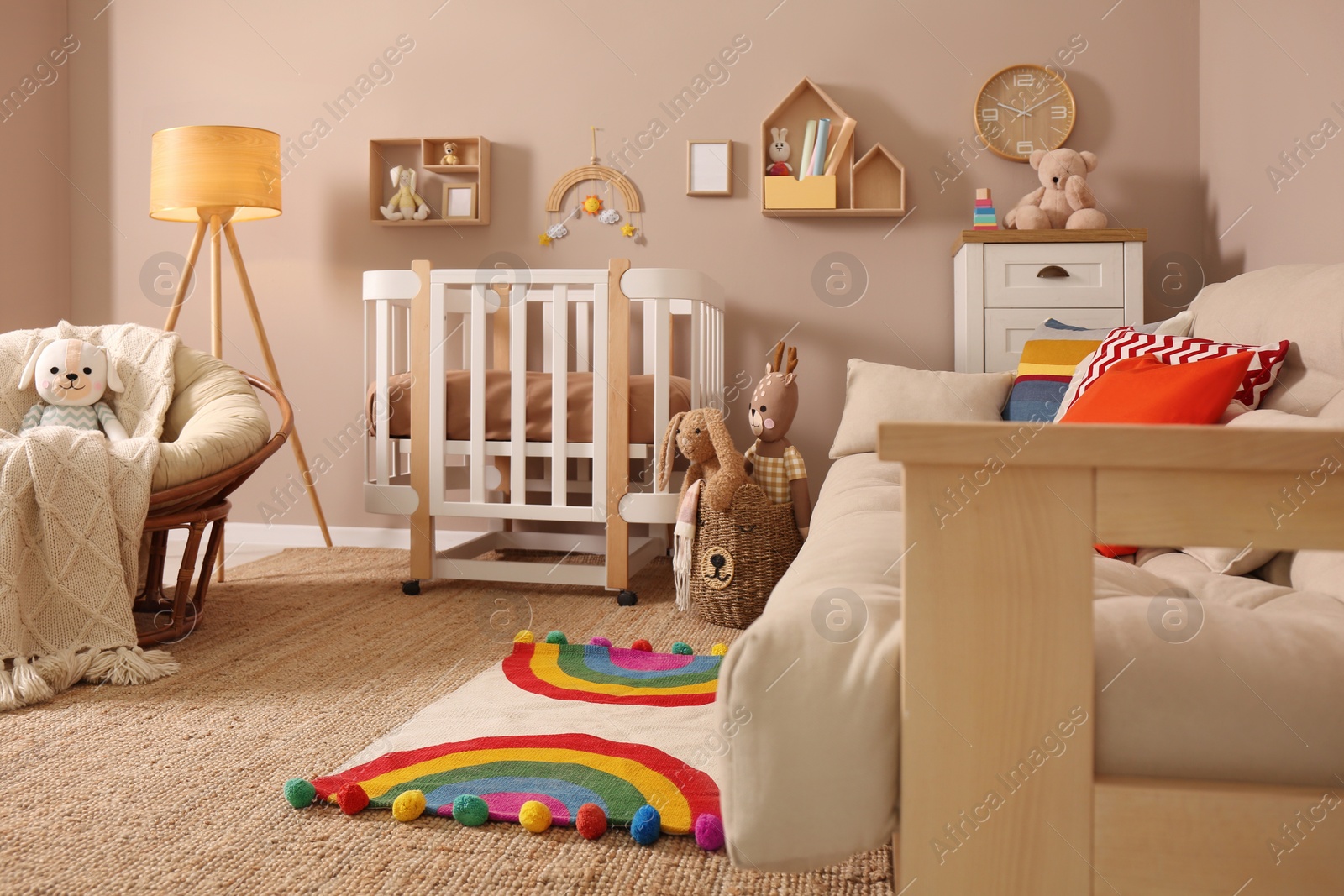 Photo of Baby room interior with stylish furniture and comfortable crib