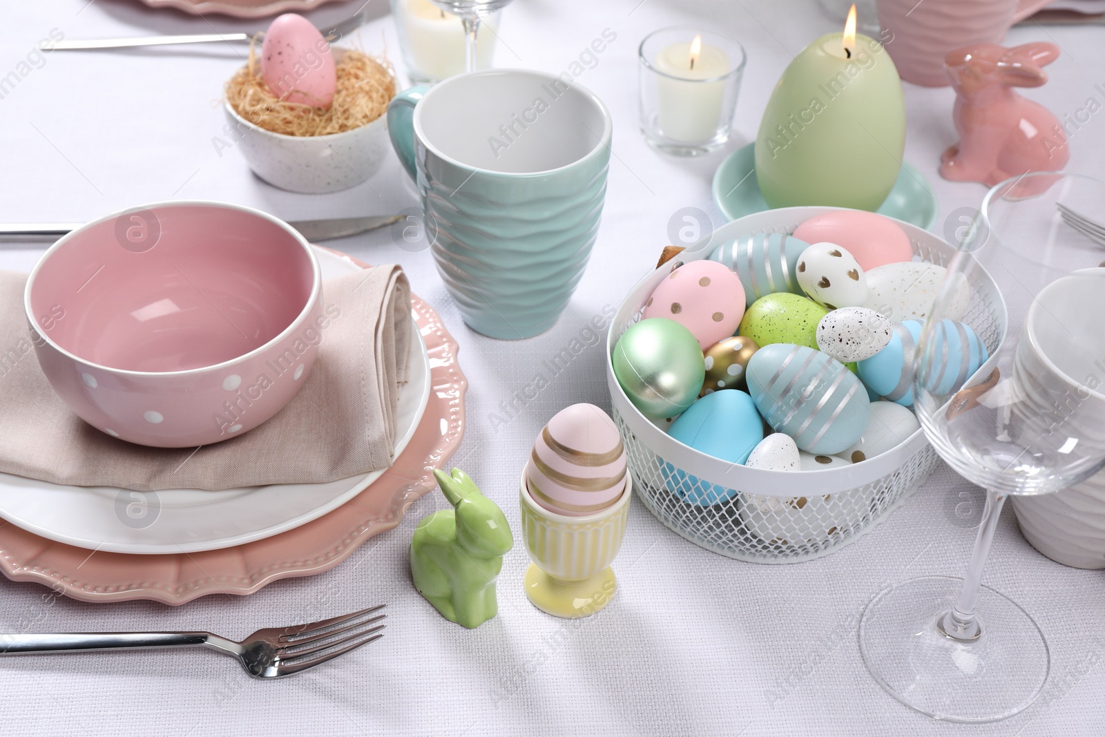 Photo of Festive table setting with painted eggs. Easter celebration