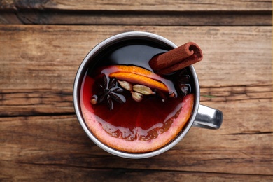 Aromatic mulled wine on wooden table, top view