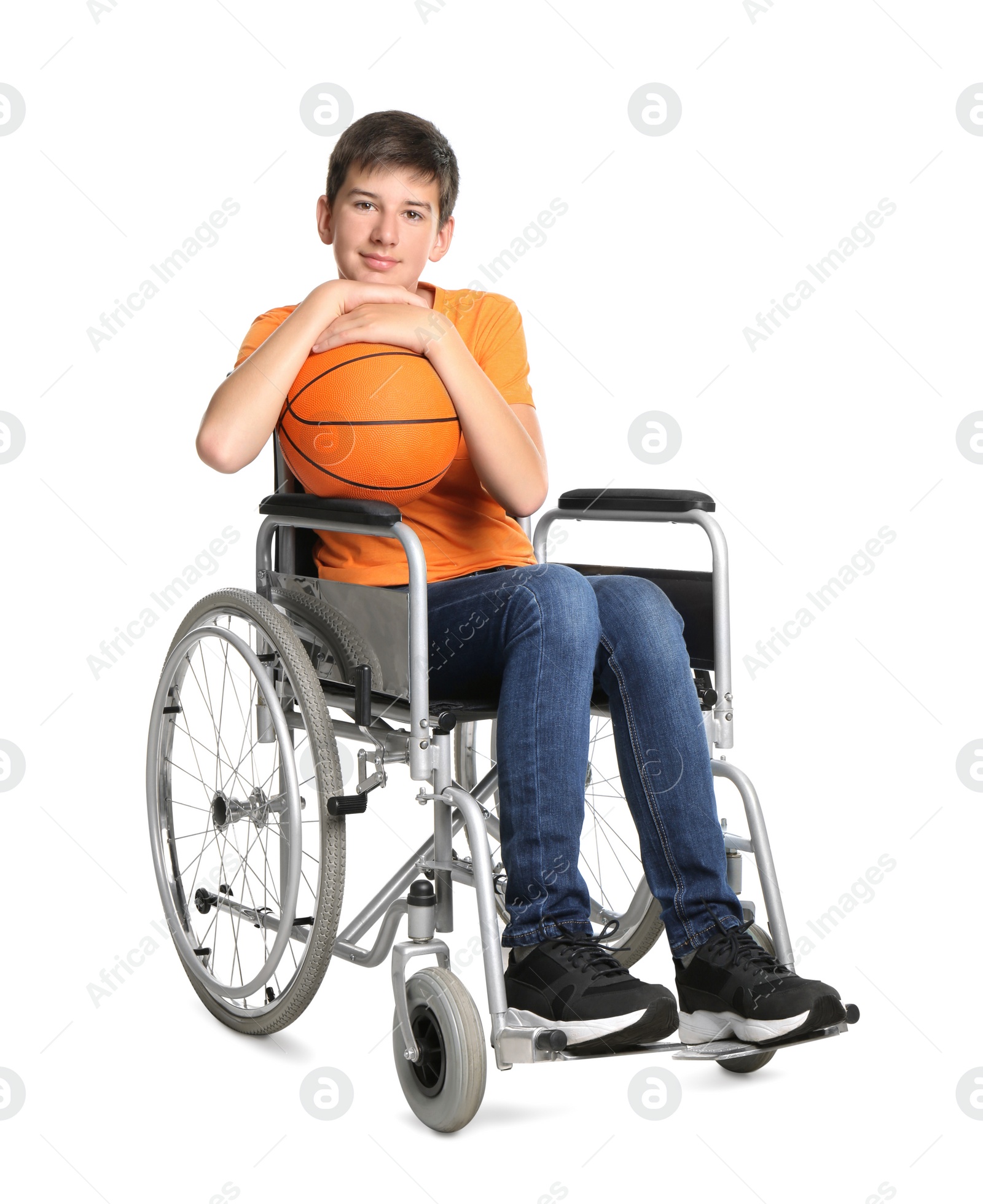 Photo of Disabled teenage boy in wheelchair with basketball ball on white background