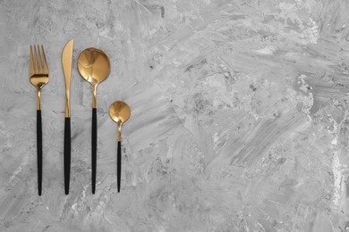 Photo of Beautiful cutlery set on grey table, flat lay. Space for text