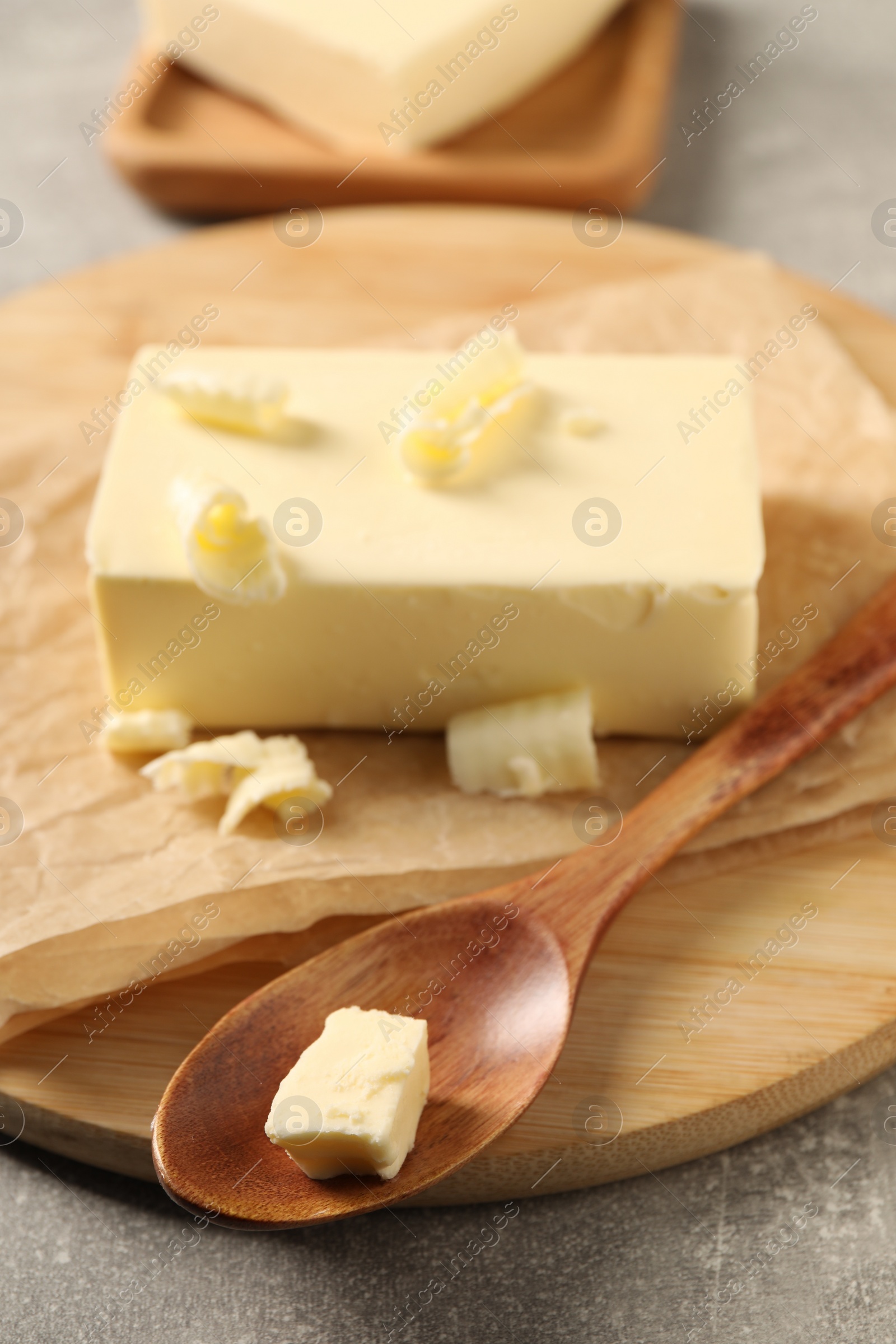 Photo of Block of tasty butter on grey table