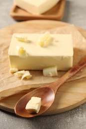 Block of tasty butter on grey table