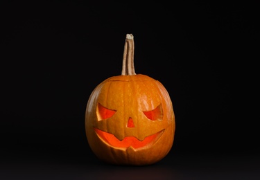 Pumpkin head on black background. Jack lantern - traditional Halloween decor