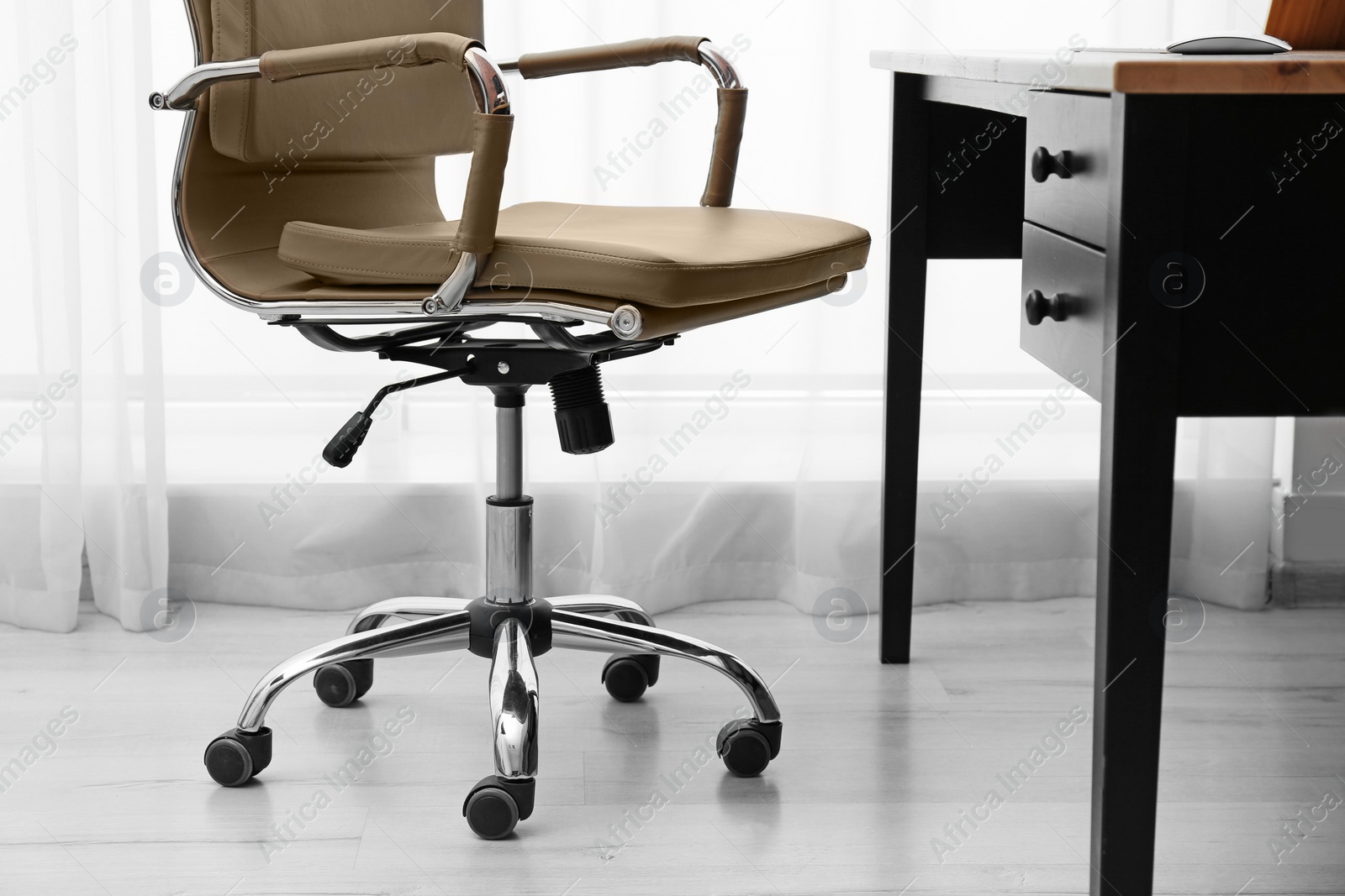 Photo of Modern office chair in stylish workplace interior