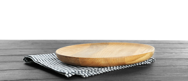 Photo of Empty plate and napkin on dark wooden table