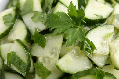 Delicious cucumber salad as background, top view