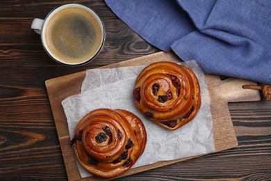 Delicious pastries and coffee on wooden table, flat lay