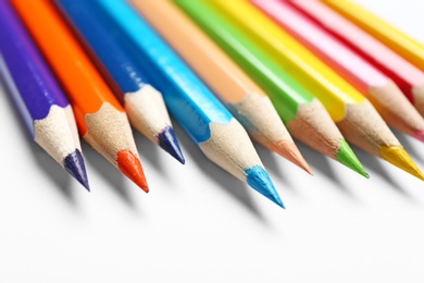 Photo of Different color pencils on white background, closeup