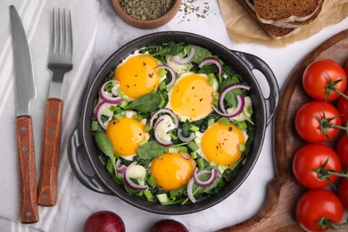 Tasty Shakshouka served on white marble table, flat lay