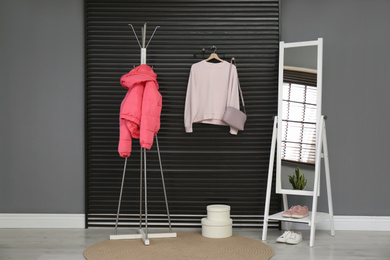 Hallway interior with stylish furniture, clothes and accessories