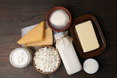 Photo of Different fresh dairy products on wooden table, top view