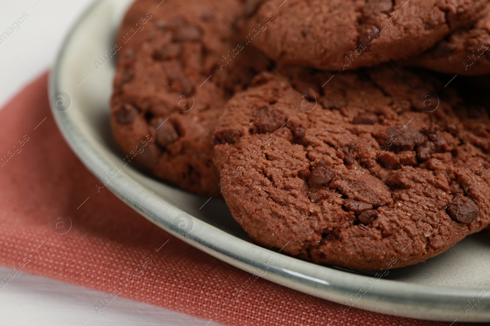 Photo of Delicious chocolate chip cookies on white table, closeup