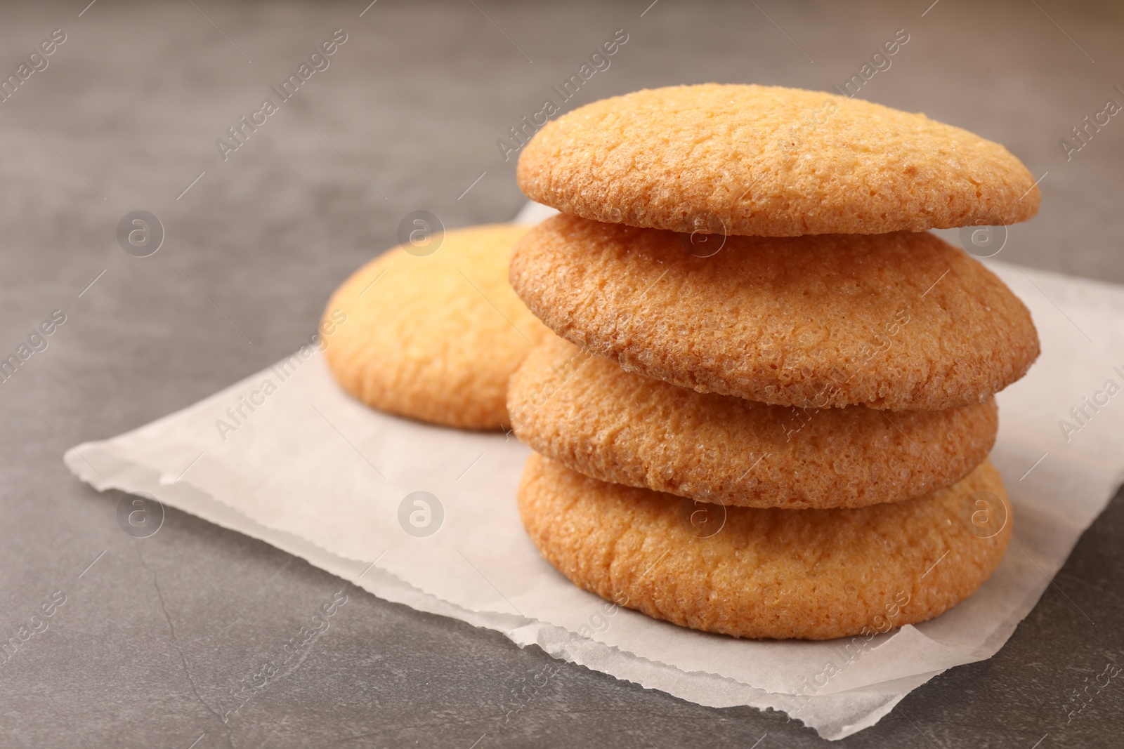 Photo of Delicious Danish butter cookies on grey table, closeup. Space for text