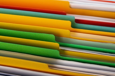 Photo of Many different files with documents as background, closeup