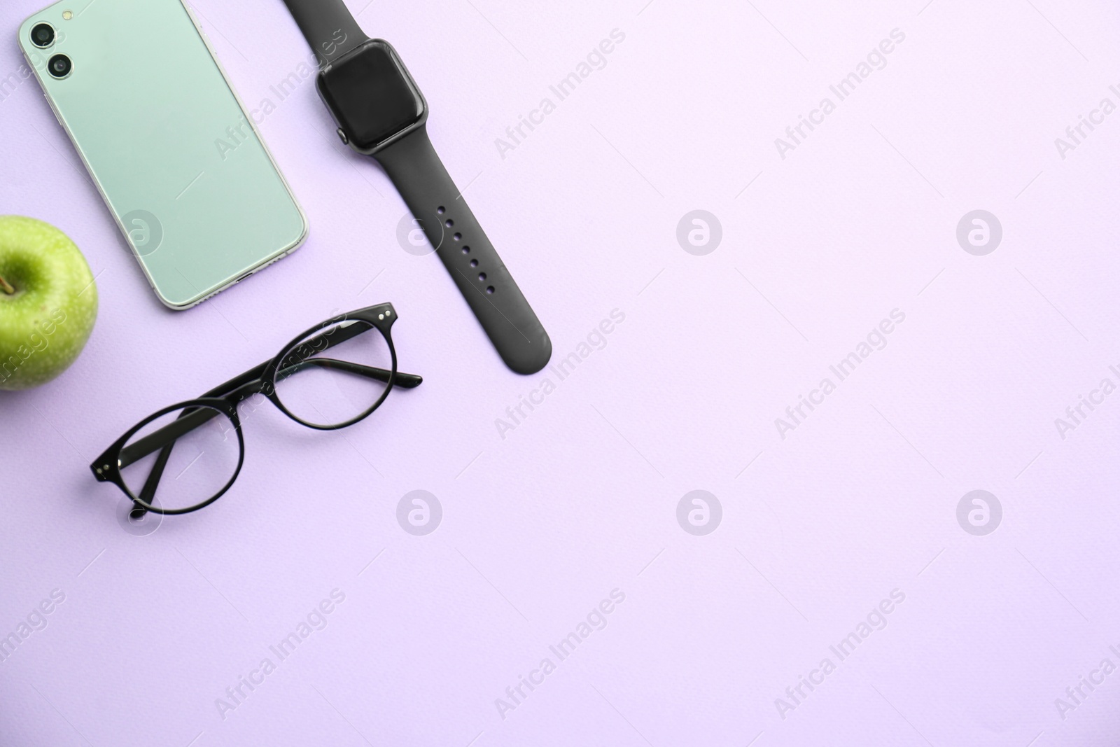 Flat lay composition with stylish smart watch on violet background. Space for text Photo of Flat lay composition with stylish smart watch on violet background. Space for text