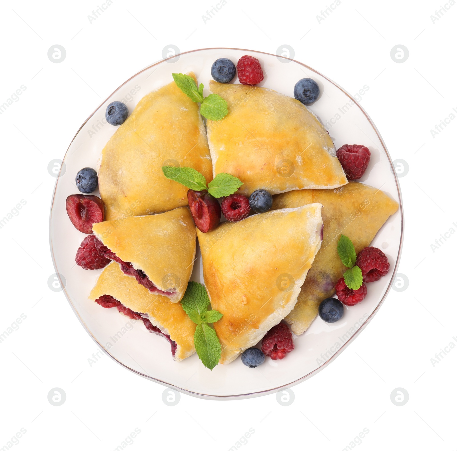 Photo of Plate of tasty samosas with berries and mint leaves isolated on white, top view